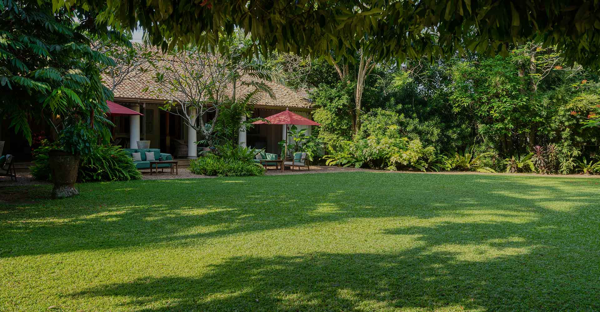 The Wallawwa a luxury boutique hotel in Negombo with a garden view, cozy outdoor seating, and peaceful tropical surroundings